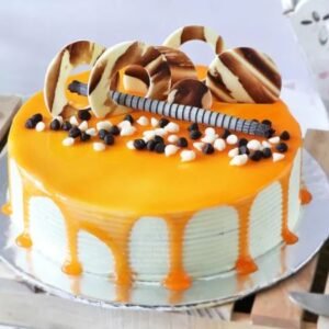 Delicious Butterscotch Cake with Chocolate Cuttings, featuring a rich butterscotch flavor topped with chocolate shavings, perfect for any celebration.