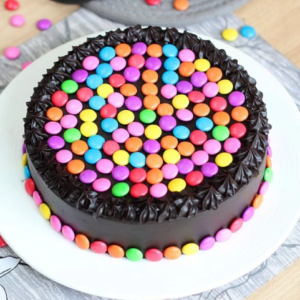 Choco Gems Delight Cake featuring rich chocolate layers topped with vibrant, colorful gems for a fun and delicious treat.