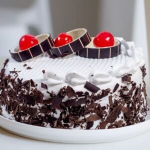 Delicious Yummy Black Forest Cake featuring layers of chocolate, cherries, and whipped cream, ideal for birthdays, celebrations, or any sweet occasion.