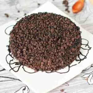 Decorated Choco Chips Cake showcasing a moist chocolate cake layered with creamy frosting and topped with vibrant choco chips for a delicious dessert.