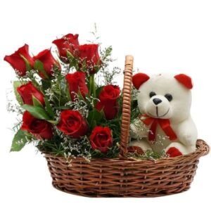 Basket arrangement with vibrant red roses and a cute teddy bear, ideal for gifts on special occasions like anniversaries, birthdays, or Valentine's Day.