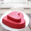 Tier Heart Cake featuring multiple layers shaped like a heart, decorated with elegant icing and floral accents, perfect for romantic celebrations.