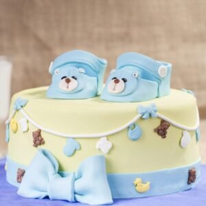 Cute Blue Baby Shoes Cake designed with adorable blue shoe decorations, ideal for celebrating a baby boy's arrival at baby showers.