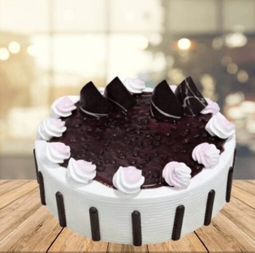 Moist and fluffy Delicious Blueberry Cake topped with fresh blueberries and creamy frosting, perfect for a fruity indulgence.