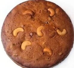 Cashew Plum Dry Cake featuring a golden-brown exterior with chunks of cashews and plums, perfect for a healthy snack.