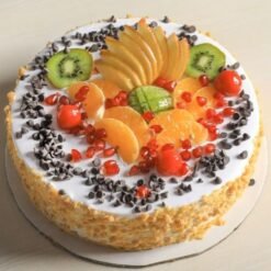 Choco Chips Mix Fruit Cake, showcasing a rich cake layered with chocolate chips and a colorful assortment of fresh fruits on top.