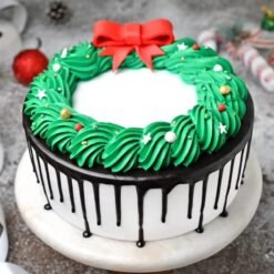 Christmas Black Forest Cake adorned with festive decorations, rich chocolate layers, and cherries, perfect for holiday celebrations and gatherings.