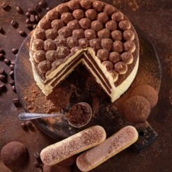 Creamy Coffee Bliss Cake with rich coffee layers and velvety cream, garnished with coffee beans and served on a decorative plate.