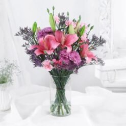 Floral Lily Charm Delight showcasing a stunning arrangement of vibrant lilies, perfect for adding elegance and charm to celebrations and home decor.