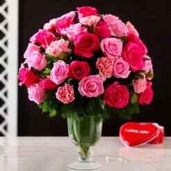 Garden Charm Roses & Carnations in Glass vase, vibrant mix of roses and carnations, elegant floral arrangement for gifting and decor.