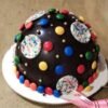 Gems Piñata Cake featuring a beautifully decorated cake designed to burst open and reveal a treasure of colorful candy gems inside.