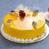 Glazed Mango Cake, featuring a moist cake base covered in a shiny mango glaze and garnished with fresh mango slices for added freshness.