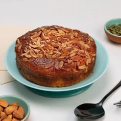 Golden Fruit Dry Cake, a moist cake filled with an assortment of dried fruits and nuts, showcasing a golden hue and rich texture.