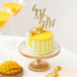 Mango Dream Cake for Mom, featuring layers of fluffy mango cake with creamy frosting, garnished with fresh mango slices and mint leaves.