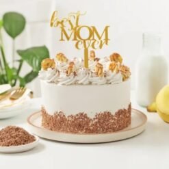 Mom's Banoffee Delight Cake featuring layers of fresh bananas, rich toffee, and creamy whipped topping, beautifully presented on a decorative plate.