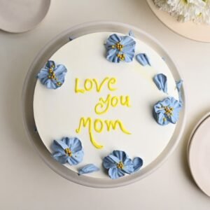 Delicious Mom's Blooming Frosted Cake adorned with floral decorations, ideal for Mother's Day and celebrations honoring moms.