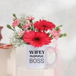 Mug Of Cheerful Blooms featuring a vibrant assortment of flowers in a charming mug, ideal for gifting and brightening up any space.