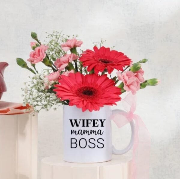 Mug Of Cheerful Blooms featuring a vibrant assortment of flowers in a charming mug, ideal for gifting and brightening up any space.