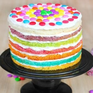 Round Rainbow Cake with vibrant layers of colorful sponge cake, beautifully frosted and adorned with sprinkles for a festive touch.