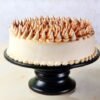 Silky Coffee Cream Cake with layers of smooth coffee cream filling and rich frosting, elegantly garnished and served on a cake stand.