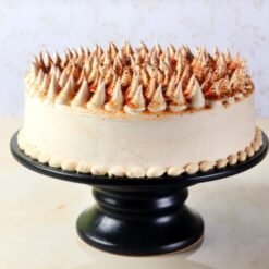 Silky Coffee Cream Cake with layers of smooth coffee cream filling and rich frosting, elegantly garnished and served on a cake stand.