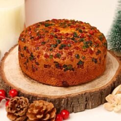 Sun-Kissed Fruit Dry Cake, a moist cake featuring a medley of colorful dried fruits, garnished with nuts and a light glaze.