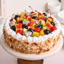 Vanilla Fruit Nutty Cake, showcasing a moist vanilla cake topped with fresh fruits and sprinkled with crunchy nuts for added texture.