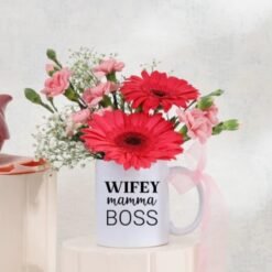 Warm Mug Of Blooms featuring a delightful arrangement of colorful flowers in a cozy mug, ideal for gifting and celebrating special occasions.