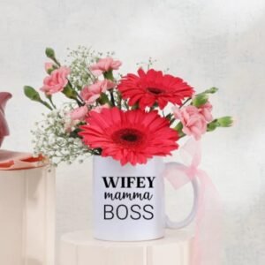 Warm Mug Of Blooms featuring a delightful arrangement of colorful flowers in a cozy mug, ideal for gifting and celebrating special occasions.