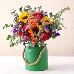 Charming Assorted Blooms in Green Jar with a colorful array of flowers arranged in a rustic green jar for cheerful decor.