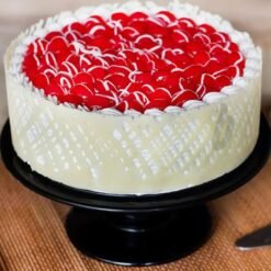 Cherry Snowfall Cake – a festive cake topped with juicy cherries and a snowy white frosting, perfect for holiday celebrations.