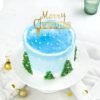 Frosted Christmas Tree Cake decorated with a snowy tree design, perfect for adding festive charm to your Christmas celebrations.