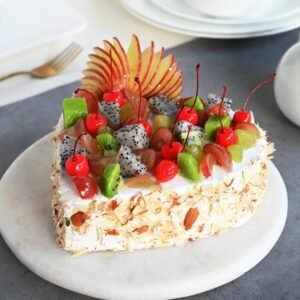 Tropical Fruit Heart Cake – a heart-shaped cake topped with vibrant tropical fruits, perfect for celebrations of love and special moments.