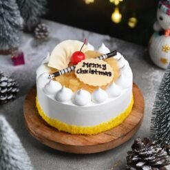 Golden Christmas Pineapple Cake adorned with festive decorations, featuring tropical pineapple flavors for a holiday treat.