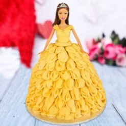 A magical Disney Princess Belle Cake featuring an elegant Belle doll in a golden frosting gown.