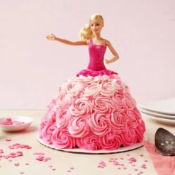 A gorgeous Rosy Radiance Barbie Cake featuring a beautifully decorated Barbie doll in an elegant pink frosting gown.