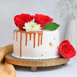 Rose Vanilla Drip Cake with elegant rose designs, smooth vanilla layers, and a sweet, golden drip, perfect for a sophisticated celebration.