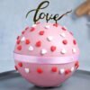 Enchanted Love Pinata Cake with a heart-shaped exterior and a burst of colorful candy surprise inside, perfect for Valentine's Day and romantic occasions.