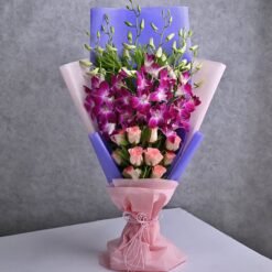 A beautiful bouquet of vivid orchids and elegant roses in assorted colors, accented with lush greenery.