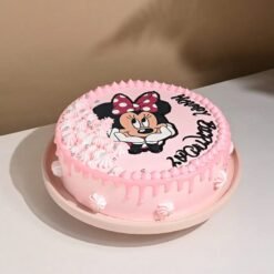 Adorable Minnie Mouse-themed birthday cake with vibrant colors, playful decorations, and a charming design for kids' parties.