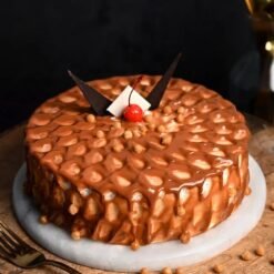 Velvety Caramel Butterscotch Cake topped with caramel drizzle, butterscotch chips, and creamy frosting.