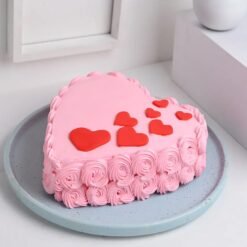 Beautiful heart-shaped cake decorated with delicate rose swirls and a romantic touch.