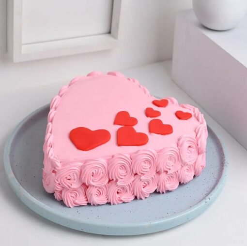 Beautiful heart-shaped cake decorated with delicate rose swirls and a romantic touch.