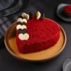 Scarlet Bliss Heart Cake with vibrant red layers, delicate decoration, and smooth icing, shaped in a heart.