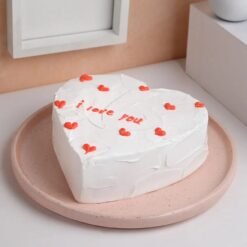 Beautiful heart-shaped vanilla cake with creamy frosting, perfect for special occasions.